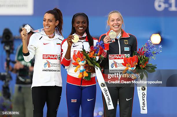 Ivet Lalova-Collio of Bulgaria , Dina Asher-Smith of Great Britain and Gina Luckenkemper of Germany pose for a picture on the podium after receiving...