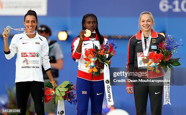 Ivet Lalova-Collio of Bulgaria , Dina Asher-Smith of Great Britain and Gina Luckenkemper of Germany pose for a picture on the podium after receiving...