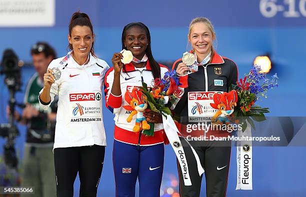Ivet Lalova-Collio of Bulgaria , Dina Asher-Smith of Great Britain and Gina Luckenkemper of Germany pose for a picture on the podium after receiving...
