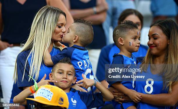 Ludivine Payet , wife of Dimitri Payet of France kisses her child prior to the UEFA EURO semi final match between Germany and France at Stade...