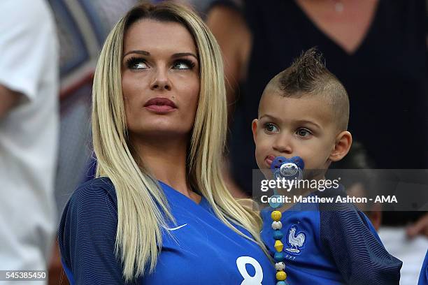 Dimitri Payet's wife Ludivine Payet looks on with their son Milan prior to the UEFA Euro 2016 Semi Final match between Germany and France at Stade...