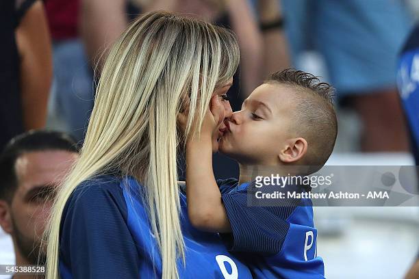 Dimitri Payet's wife Ludivine Payet looks on with their son prior to the UEFA Euro 2016 Semi Final match between Germany and France at Stade...
