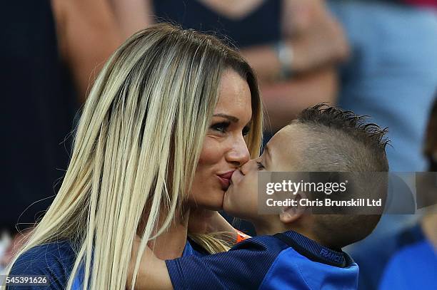 Ludivine Payet, wife of Dimitri Payet of France, kisses her child priorduring the UEFA Euro 2016 Semi Final match between Germany and France at Stade...