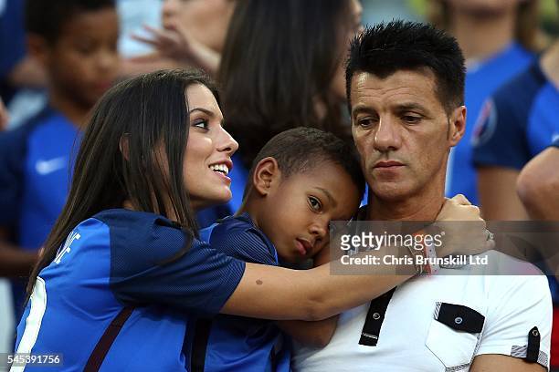 Ludivine Sagna, wife of Bacary Sagna of France, embraces her child during the UEFA Euro 2016 Semi Final match between Germany and France at Stade...