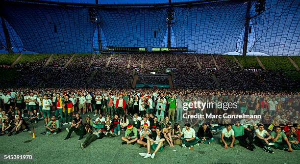 Supporters of the German national soccer team watch the UEFA EURO 2016 match between Germany and France at the public viewing area in the Olympia...