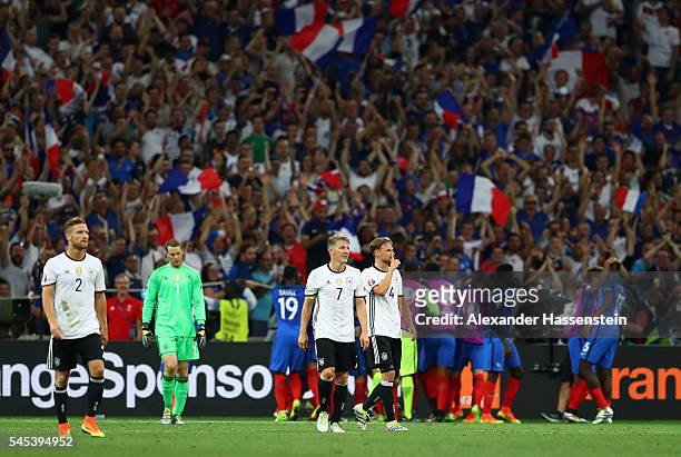 Shkodran Mustafi, Manuel Neuer, Bastian Schweinsteiger and Benedikt Hoewedes of Germany show their dejection after France's second goal during the...