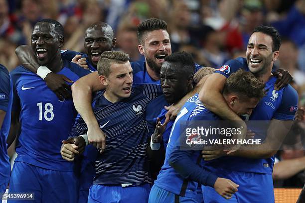France's players celebrate after winning the Euro 2016 semi-final football match between Germany and France at the Stade Velodrome in Marseille on...