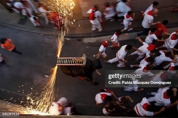 Toro del Fuego is run through the streets of Pamplona during the second day of the San Fermin Running of the Bulls festival on July 7, 2016 in...