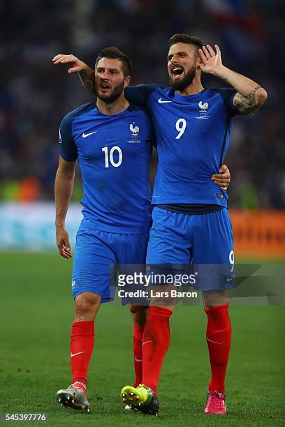 Olivier Giroud and Andre-Pierre Gignac of France celebrate after their team's 2-0 win in the UEFA EURO semi final match between Germany and France at...