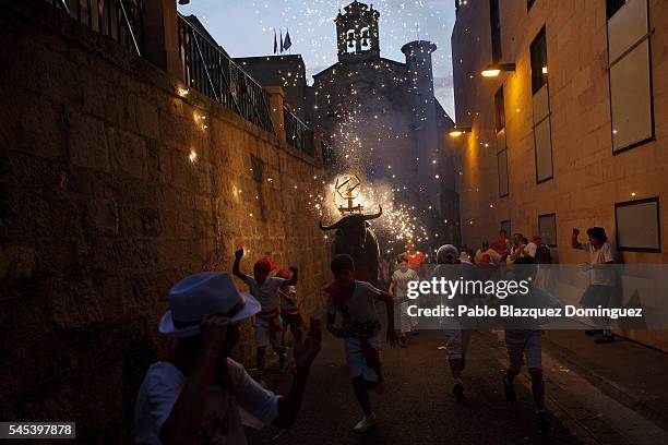Toro del Fuego is run through the streets of Pamplona during the second day of the San Fermin Running of the Bulls festival on July 7, 2016 in...