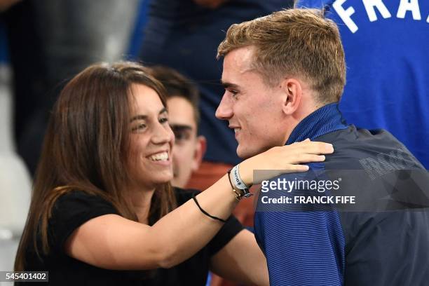 France's forward Antoine Griezmann hugs his girlfriend Erika Choperena as he celebrates the team's 2-0 win over Germany in the Euro 2016 semi-final...