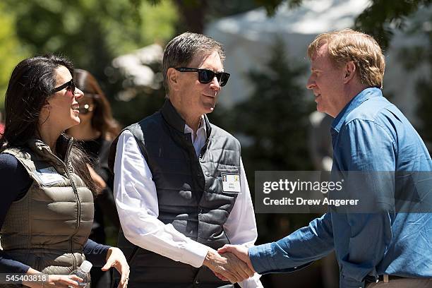 Linda Pizzuti Henry looks on as John Henry, owner of the Boston Red Sox baseball franchise and owner of Liverpool F.C. Soccer club, shakes hands with...