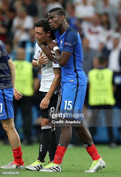 Paul Pogba of France hugs Mesut Ozil of Germany following the UEFA Euro 2016 semi final match between Germany and France at Stade Velodrome in...