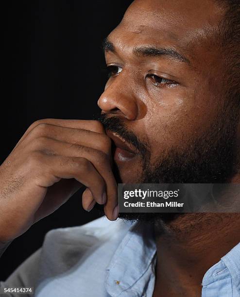 Mixed martial artist Jon Jones listens during a news conference at MGM Grand Hotel & Casino to address being pulled from his light heavyweight title...