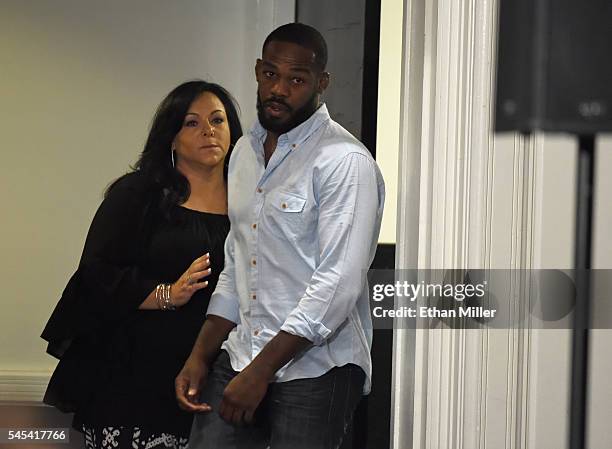 Founder and CEO of EAG Sports Management Denise White walks with mixed martial artist Jon Jones as he returns after temporarily leaving a news...