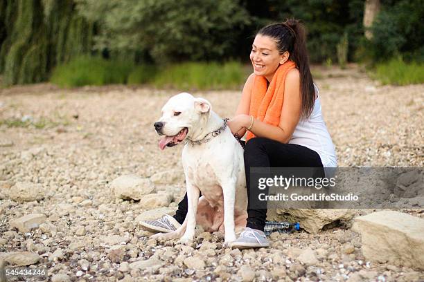 young woman having fun with her dog - dogo argentino stock pictures, royalty-free photos & images