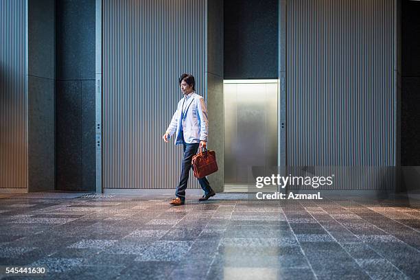 taking a quick break - business man walking with a bag in asia bildbanksfoton och bilder