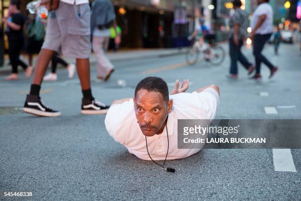Man lays on the ground after yelling "Don't shoot me" at police during a rally in Dallas, Texas, on Thursday, July 7, 2016 to protest the deaths of...