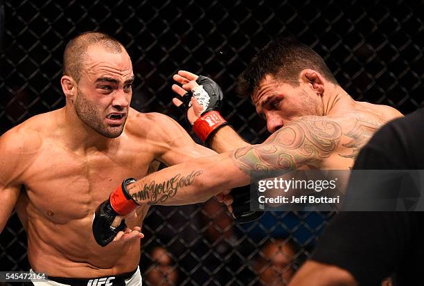 Eddie Alvarez connects with a left against Rafael Dos Anjos of Brazil in their lightweight championship bout during the UFC Fight Night event inside...