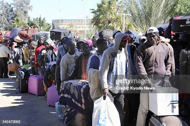Tunisia - Refugees from Libya wait in lines for immigration clearance after crossing the border at Ras Ajdir, southeastern Tunisia, on March 2, 2011....