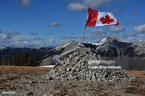 flag on mountain - canadian flag stock pictures, royalty-free photos & images