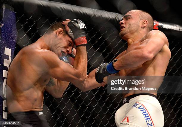 Eddie Alvarez punches Rafael Dos Anjos of Brazil in their lightweight championship bout during the UFC Fight Night event inside the MGM Grand Garden...