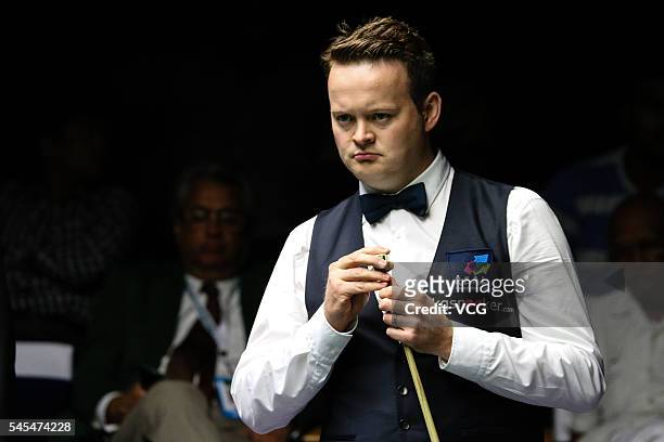 Shaun Murphy of England chalks his cue in second round match against Michael Georgiou of England on day three of Indian Open 2016 at Hyderabad...