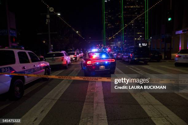 Police cars sit on Main Street in Dallas following the sniper shooting during a protest on July 7, 2016. A fourth police officer was killed and two...