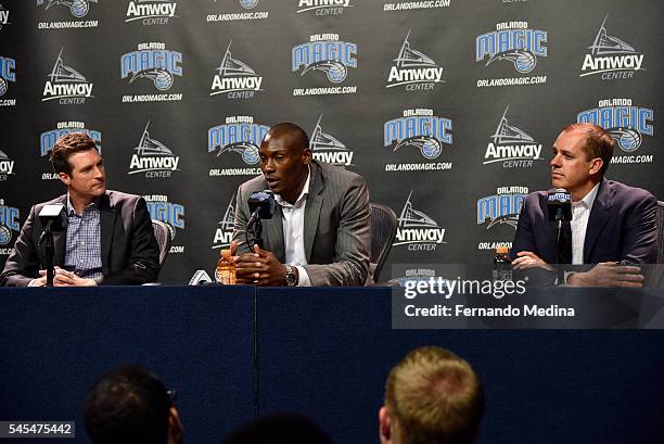 Orlando Magic general manager Rob Hennigan and head coach Frank Vogel introduce new Magic player Bismack Biyombo during a press conference on July 7,...
