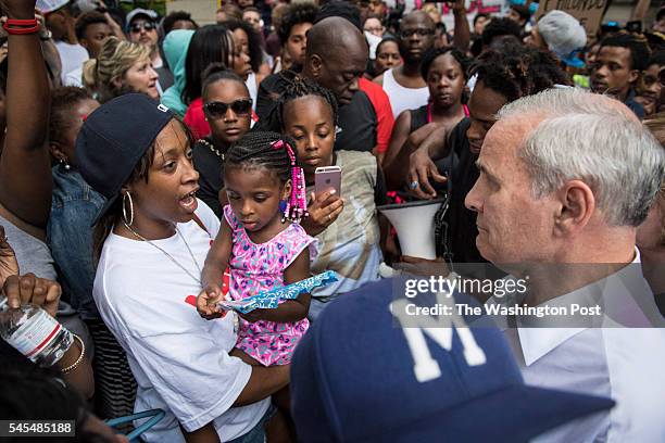 Minnesota Gov. Mark Dayton, right, apologizes to Diamond Reynolds, left, the girlfriend of Philando Castile, during a demonstration outside the...