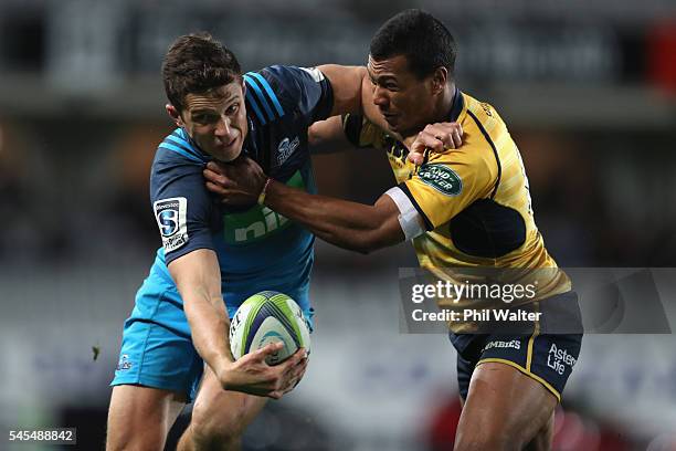 Matt Duffie of the Blues is tackled by Aidan Toua of the Brumbies during the round 16 Super Rugby match between the Blues and the Brumbies at Eden...