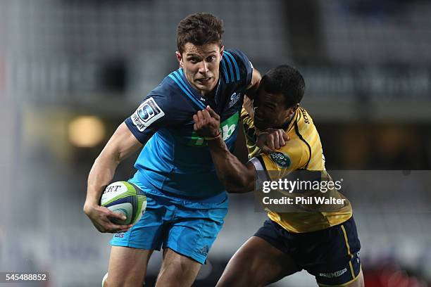 Matt Duffie of the Blues is tackled by Aidan Toua of the Brumbies during the round 16 Super Rugby match between the Blues and the Brumbies at Eden...