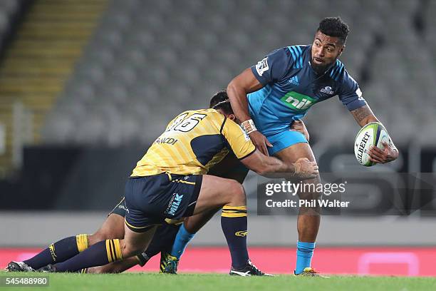 Lolagi Visinia of the Blues is tackled during the round 16 Super Rugby match between the Blues and the Brumbies at Eden Park on July 8, 2016 in...