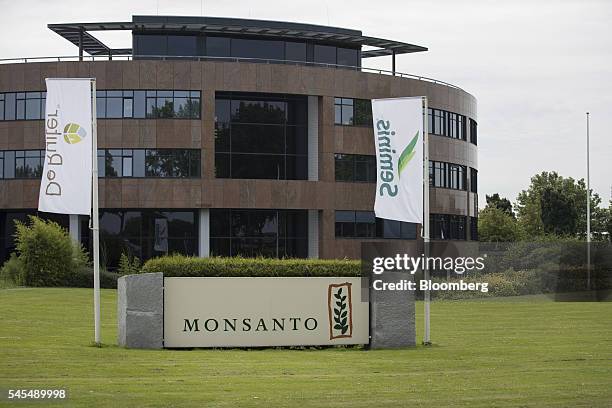 Banners fly outside the offices of De Ruite and Seminis, the vegetable seeds division of Monsanto Co., in Bergschenhoek, Netherlands, on Thursday,...