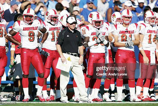 Head coach Bobby Petrino of the Louisville Cardinals looks on from the sidelines with his players during the game against the Kentucky Wildcats on...