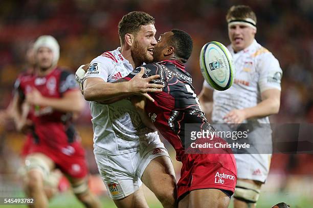 Tawera Kerr Brown of the Chiefs passes while tackled by Samu Kerevi of the Reds during the round 16 Super Rugby match between the Reds and the Chiefs...