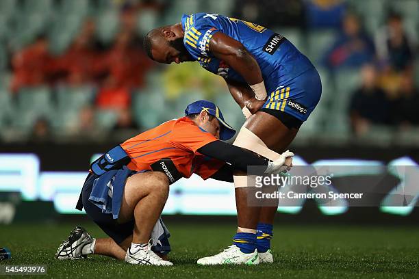 Semi Radradra of the Eels receives attention after a tackle during the round 18 NRL match between the Parramatta Eels and the Sydney Roosters at...