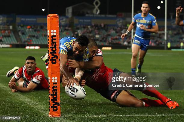 Bevan French of the Eels is tackled over the sideline as he attempts to score a try during the round 18 NRL match between the Parramatta Eels and the...
