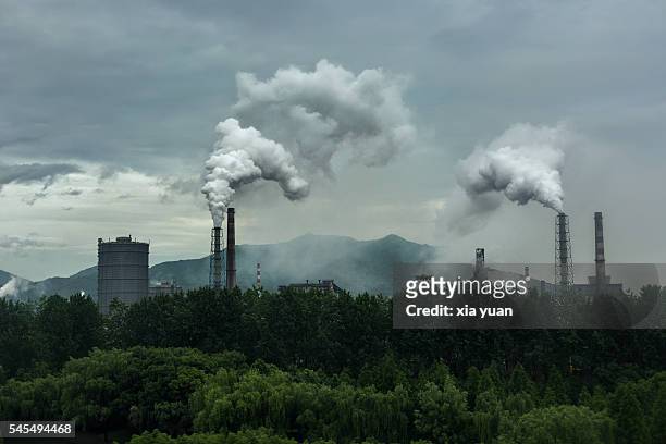 smoke emitting from industry against sky,hangzhou,china - charcoal stockfoto's en -beelden