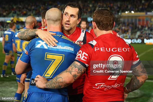 Mitchell Pearce and Jake Friend of the Roosters congratulate Jeff Robson of the Eels after the Eels victory in the round 18 NRL match between the...