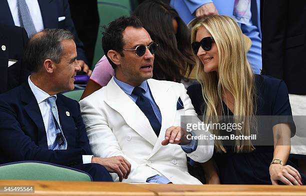 Mark Cairney, Jude Law and Phillipa Coan watch on as Roger Federer of Switzerland plays Milos Raonic of Canada in the Men's Singles Semi Final match...