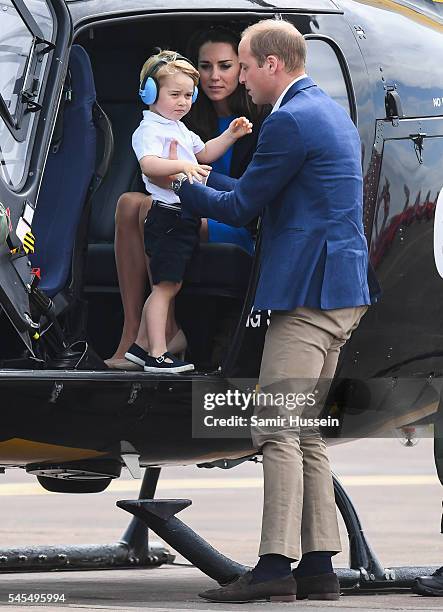 Catherine, Duchess of Cambridge, Prince George of Cambridge and Prince William, Duke of Cambridge sit in a helicopter as they attend the The Royal...