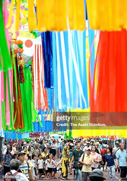 People walk under the 'Tanabata' ornaments as the Shonan Hratsuka Tanabata Festival begins on July 8, 2016 in Hiratsuka, Kanagawa, Japan. Tanabata is...