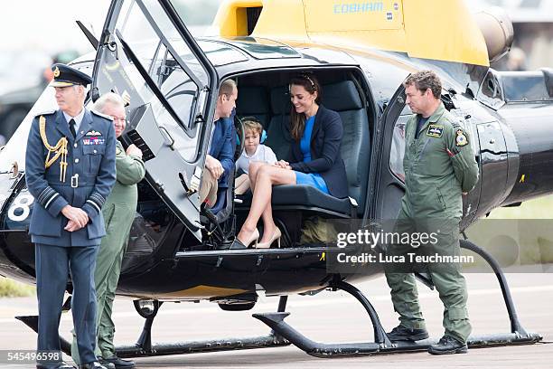 Prince William, Duke of Cambridge, Catherine, Duchess of Cambridge and Prince George sit inside a Squirrel helicopter during a visit to the Royal...