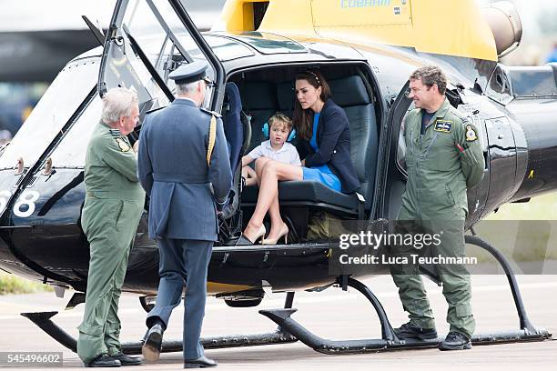 Prince William, Duke of Cambridge, Catherine, Duchess of Cambridge and Prince George sit inside a Squirrel helicopter during a visit to the Royal...