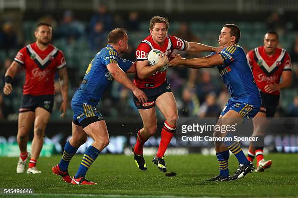 Mitchell Aubusson of the Roosters is tackled during the round 18 NRL match between the Parramatta Eels and the Sydney Roosters at Pirtek Stadium on...