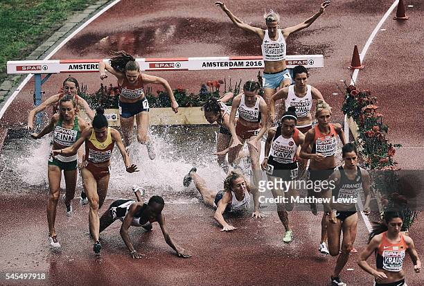 Lennie Waite of Great Britain falls at the water jump with Meryem Akda of Turkey during the 3000m Steeplechase Women heat during day three of the...
