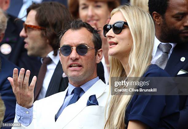 Jude Law and Phillipa Coan watch on as Roger Federer of Switzerland plays Milos Raonic of Canada in the Men's Singles Semi Final match on day eleven...