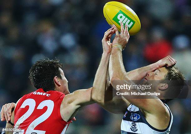 Lachie Henderson of the Cats marks the ball against Dean Towers of the Swans during the round 16 AFL match between the Geelong Cats and the Sydney...