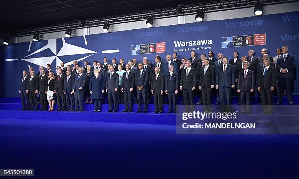 President Barack Obama and Polish President Andrzej Duda pose with other leaders at the start of a NATO summit on July 8, 2016 at the Belweder Palace...